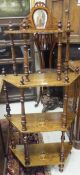 A late Victorian walnut and marquetry inlaid four tier whatnot