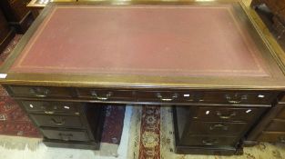 A mahogany pedestal desk, the top with writing surface and moulded edge above three frieze drawers,