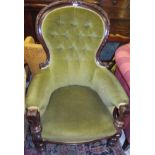 A 19th Century mahogany framed spoon button back salon chair with green velvet upholstery