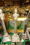 A pair of modern plated Corinthian column table lamps, another similar smaller lamp,