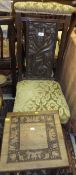 A circa 1900 carved oak nursing chair with Art Nouveau style back panel,