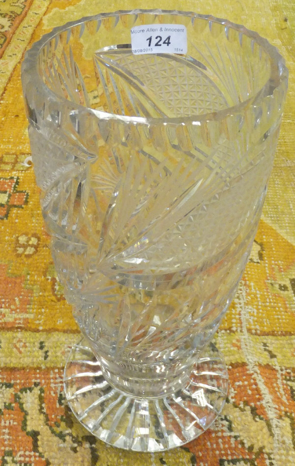 A large cut glass vase on circular star cut foot