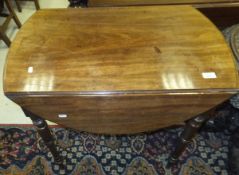 A Victorian mahogany oval drop leaf Pembroke table with single end drawer opposite a dummy drawer,