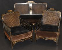 A 19th Century Chinoiserie lacquered and gilt decorated bergere suite comprising settee and two