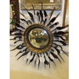 A Regency style circular giltwood convex wall mirror with later feather embellishments