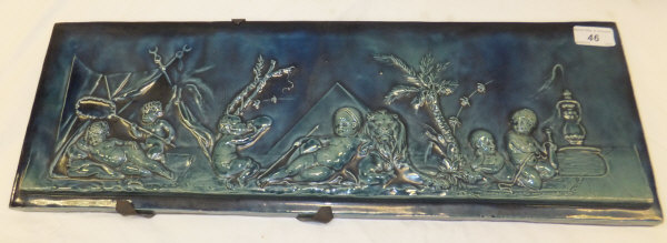 A Burmantofts style rectangular pottery plaque, relief moulded with putti leaning against a lion,