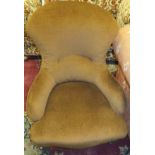 A Victorian nursing chair on walnut legs with brown upholstery