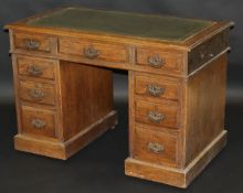A late Victorian oak pedestal desk,