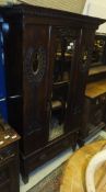 An Edwardian mahogany single door wardrobe in the Art Nouveau taste with single drawer to base,