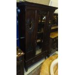 An Edwardian mahogany single door wardrobe in the Art Nouveau taste with single drawer to base,