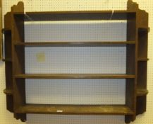 A circa 1900 oak four tier wall shelf in the Arts and Crafts taste