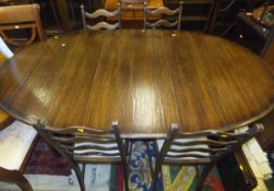 A large oak oval draw leaf dining table (with three extra leaves),