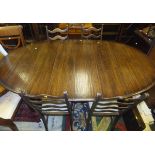 A large oak oval draw leaf dining table (with three extra leaves),