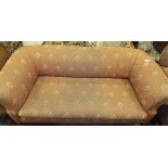 A late Victorian Chesterfield sofa on bun front feet, upholstered in terracotta foliate patterned