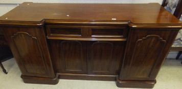 A mahogany sideboard with two cupboard doors and central single drawer with two cupboard doors