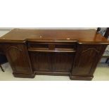 A mahogany sideboard with two cupboard doors and central single drawer with two cupboard doors