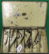A Farlow japanned spinner case containing a selection of spinning baits and accessories