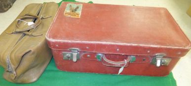 A vintage red leather suitcase stamped "San Kong Mark made in Shanghai",