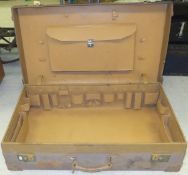 A leather-bound suitcase with fitted interior,