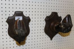 A pair of Deer slot coat hooks on oak shield shaped mounts