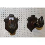 A pair of Deer slot coat hooks on oak shield shaped mounts
