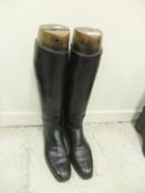 A pair of black leather riding boots with wooden trees CONDITION REPORTS Boots with cracked and