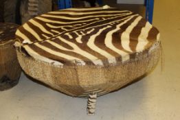 A Zebra hide covered drum table