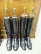 Two pairs of black leather riding boots, both with wooden trees, one set of trees by Bartley &