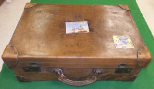 A vintage leather suitcase bearing reproduction tourist labels