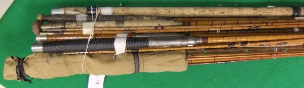 A collection of approximately 14 split cane fishing rods of varying designs,