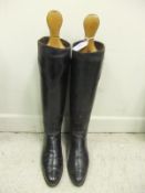 A pair of black leather riding boots with wooden trees CONDITION REPORTS With wear, scuffs, some