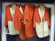 Three red hunt tail coats with brass VWH buttons, together with a further red hunt tail coat with