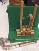 A croquet set mounted on a pine stand,