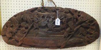 An Eastern carved wood plaque depicting a hunting scene (possibly Papua New Guinea)
