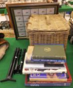 A wicker hamper containing a Harris rifle bi-pod, a rifle scope, a freestading bi-pod together