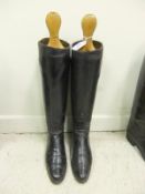 A pair of black leather riding boots with wooden trees CONDITION REPORTS Overall with wear, scuffs