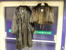 A dark brown three length fur coat,