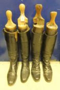 Two pairs of black leather riding boots with wooden trees, one set of trees by G Legg & Son