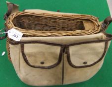 A fly fisherman's shaped wicker fishing creel together with attached canvas pouch and lid.