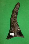 A carved Cow horn to simulate rhino horn with all over pierced decoration of flowers, fungi and