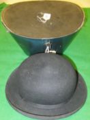 A hard top black bowler hat by Scott,