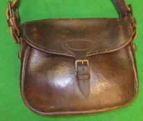 A vintage leather 100 piece cartridge bag with leather and canvas strap,
