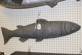 A circa 1900 un-painted metal shop sign as a half block salmon