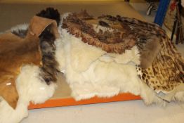 A collection of various hides, hide cushion covers, etc,