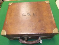 A brass-bound leather cartridge magazine bearing initials "G.W.L.