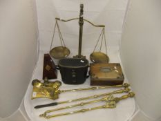 A set of three 19th Century brass fire tools, a set of brass balance scales with lion finial,