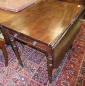 A mahogany Pembroke table on turned legs to brass castors