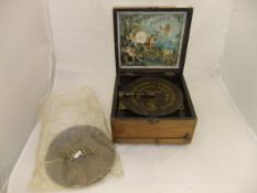 A walnut cased table top polyphon, bearing original lithographed paper label,