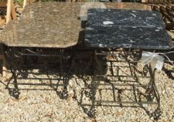 A pair of black marble topped occasional tables with wrought iron bases,
