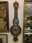 A late 19th / early 20th Century faux oak (painted) banjo thermometer / barometer with silvered